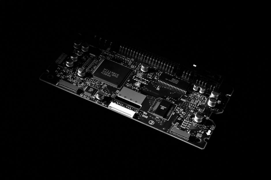 Detailed black and white image of a computer circuit board, showcasing technology components