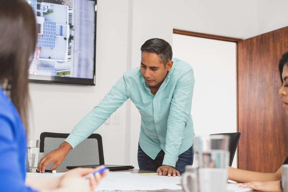 Professional businessman leading a planning session in a modern office. Ideal for business and teamwork themes.
