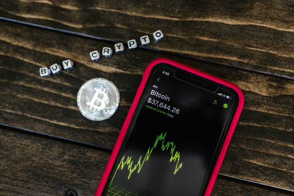 Smartphone showing bitcoin price with a physical coin and text representing cryptocurrency investment