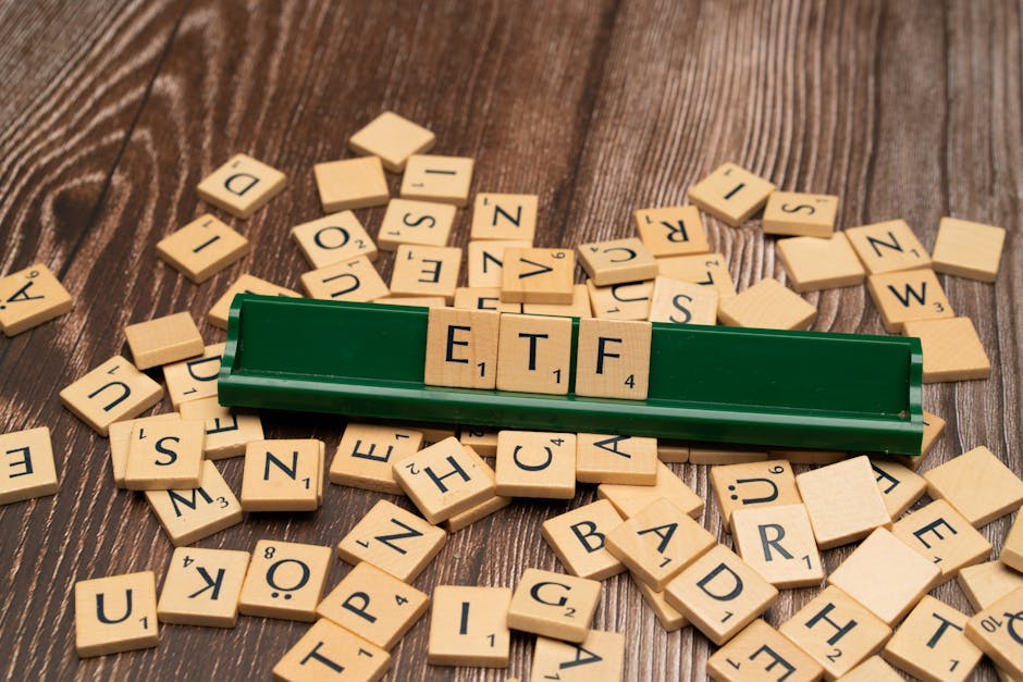Wooden tiles spelling ETF on a game holder, representing investment themes